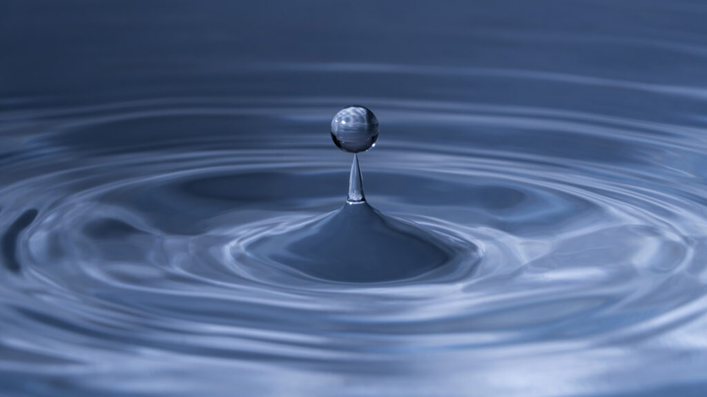 a drop of water creating ripples.