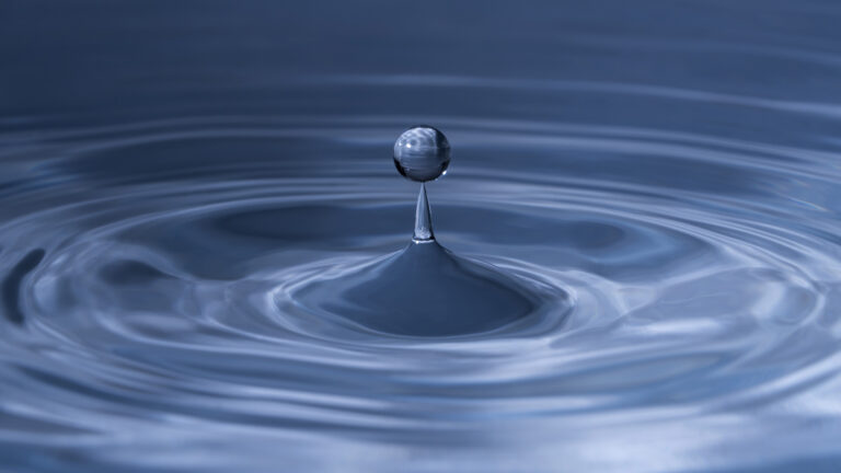 a drop of water creating ripples.